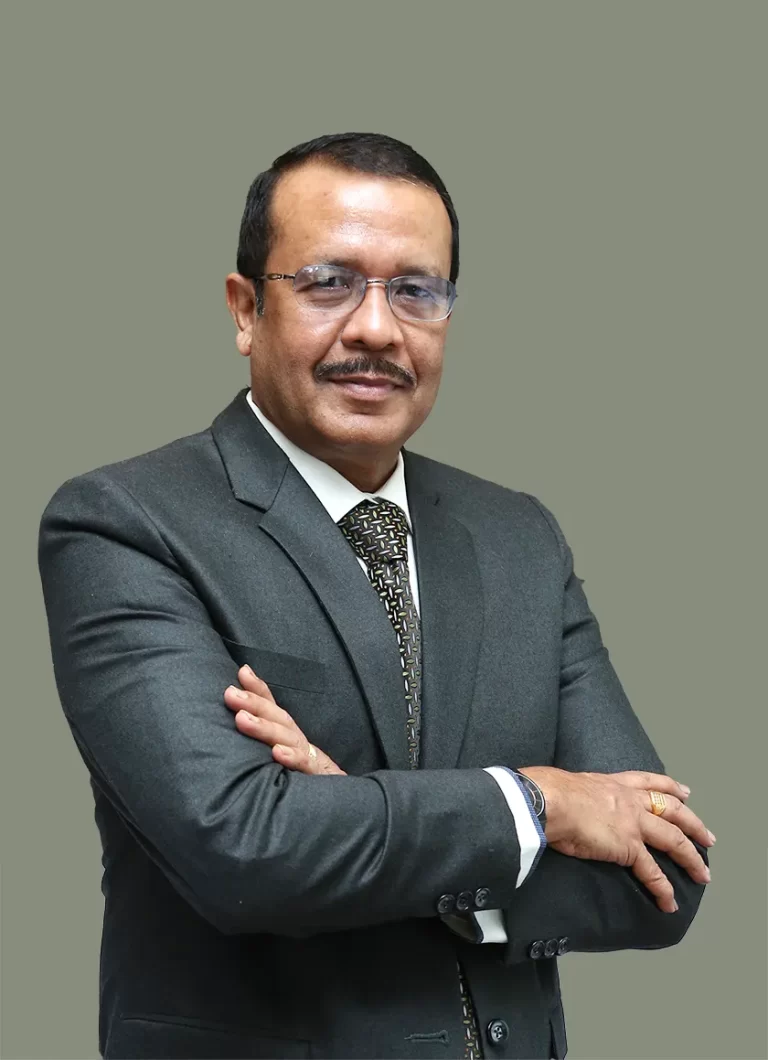 Rabi Dasgupta, Co-Founder and Managing Director of Acumen Global, in formal attire, standing confidently with folded arms.
